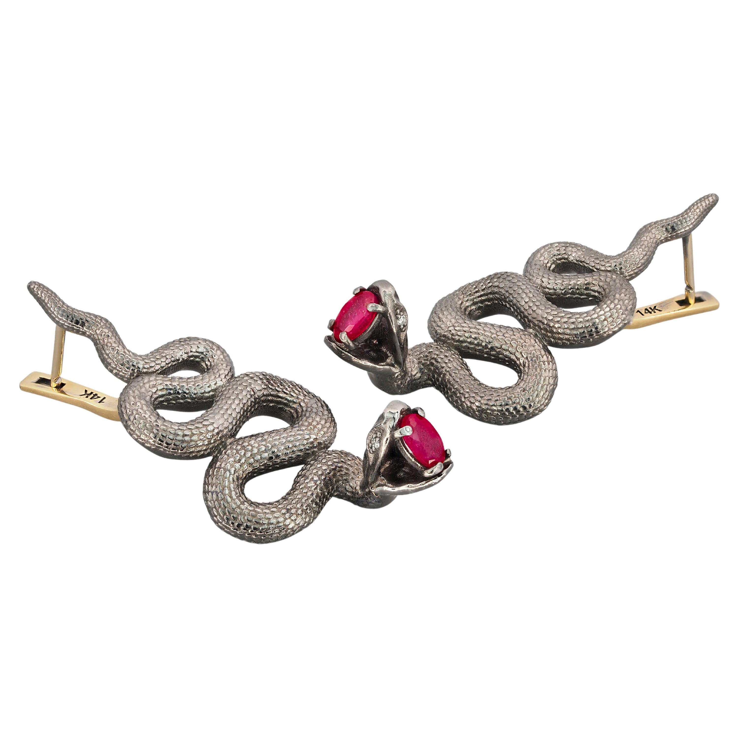 Massive snake earrings with natural rubies in opened mouth and diamonds in eyes. July birthstone.

Earrings are made with two material: 
14 kt solid yellow gold - clasp.
925 purity silver - other parts.
Gold: 1.5 g.
Silver: 12 g.
Total weight: 13.5