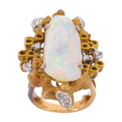 Gold design ring with a large opal and diamonds