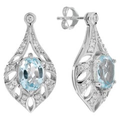 Pendants d'oreilles en or blanc 14 carats avec topaze bleue et diamant.