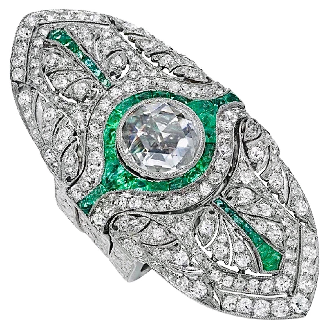 This one-of-a-kind, art deco diamond and emerald ring was originally a brooch from the 1930’s. The center rose-cut diamond is a beautiful 1.43-carat E/ VS2 diamond, GIA certified.
The piece is made in platinum with intricate artisan hand engraving
