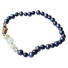 Bracelet en perles opales et noires J DAUPHIN
