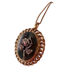 Antique Victorian era 18K gold pendant with diamond ruby flower on bloodstone