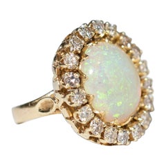 4.25ct Ethiopian Opal ring surround by 18 diamonds - 14k yellow gold 