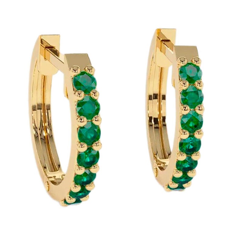Hoop Earrings with Emeralds. Huggy hoop emerald earrings in 14 Karat