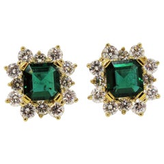 4.70 Carat Emerald Cut Emerald and Diamond Halo Stud Earrings 18 Karat Gold