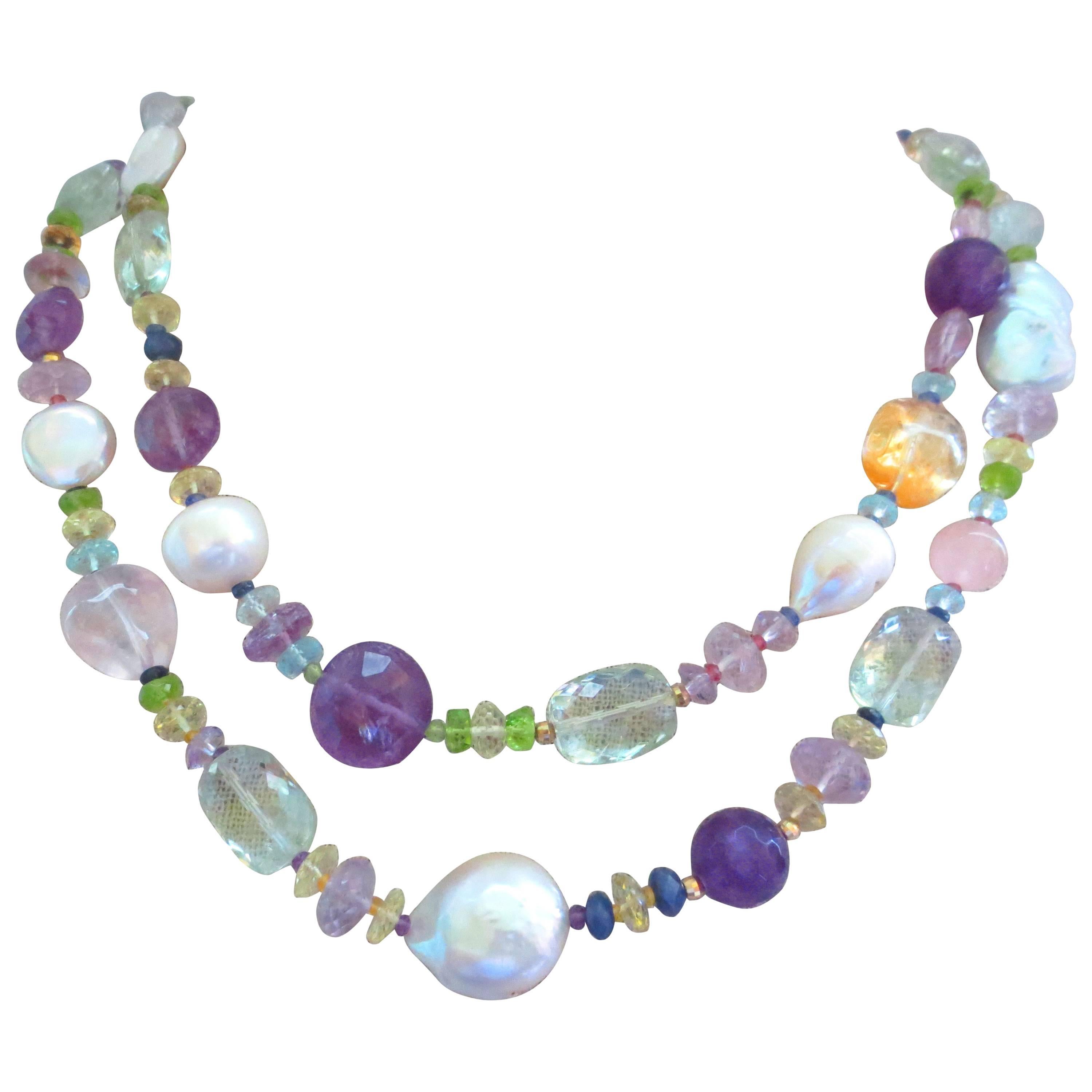 Amethyst, Citrine, Aquamarine, Peridot, Rose Quartz, Iolite, Baroque and coin  Pearls, Sapphire, and Garnet beads are combined to create a gorgeous shimmering piece. This stunning necklace can be worn long, or wrapped (with or without tassel) and is