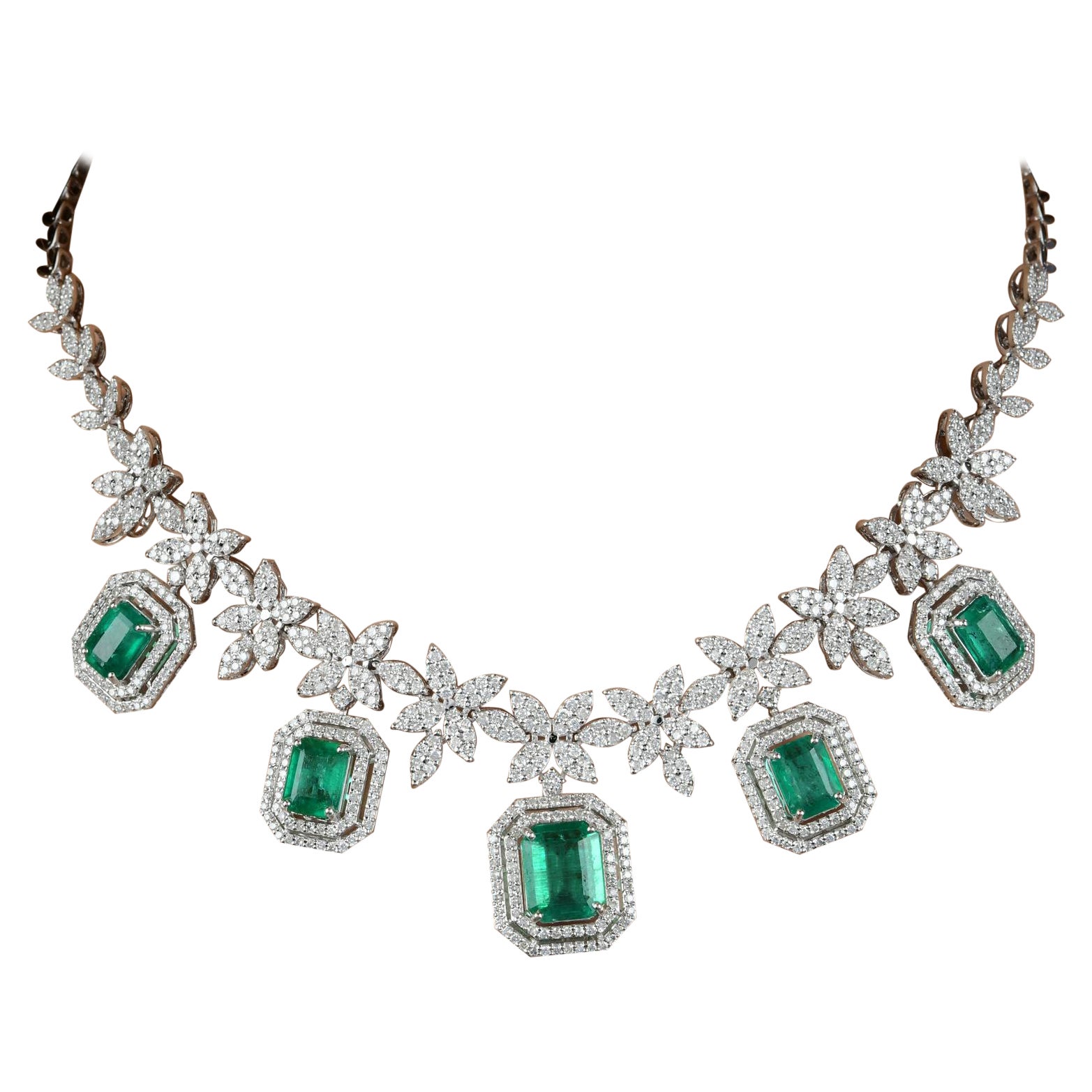Make a celestial statement with this exquisite Zambian Emerald Gemstone Charm Multi Star Necklace. With its captivating emerald gemstones, diamond accents, and 18-karat white gold craftsmanship, it is a stunning addition to your jewelry collection