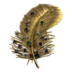 Vintage Broche “ plume ”en or 18 Carats ornée d’émeraudes, Diamants, saphirs et rubis 