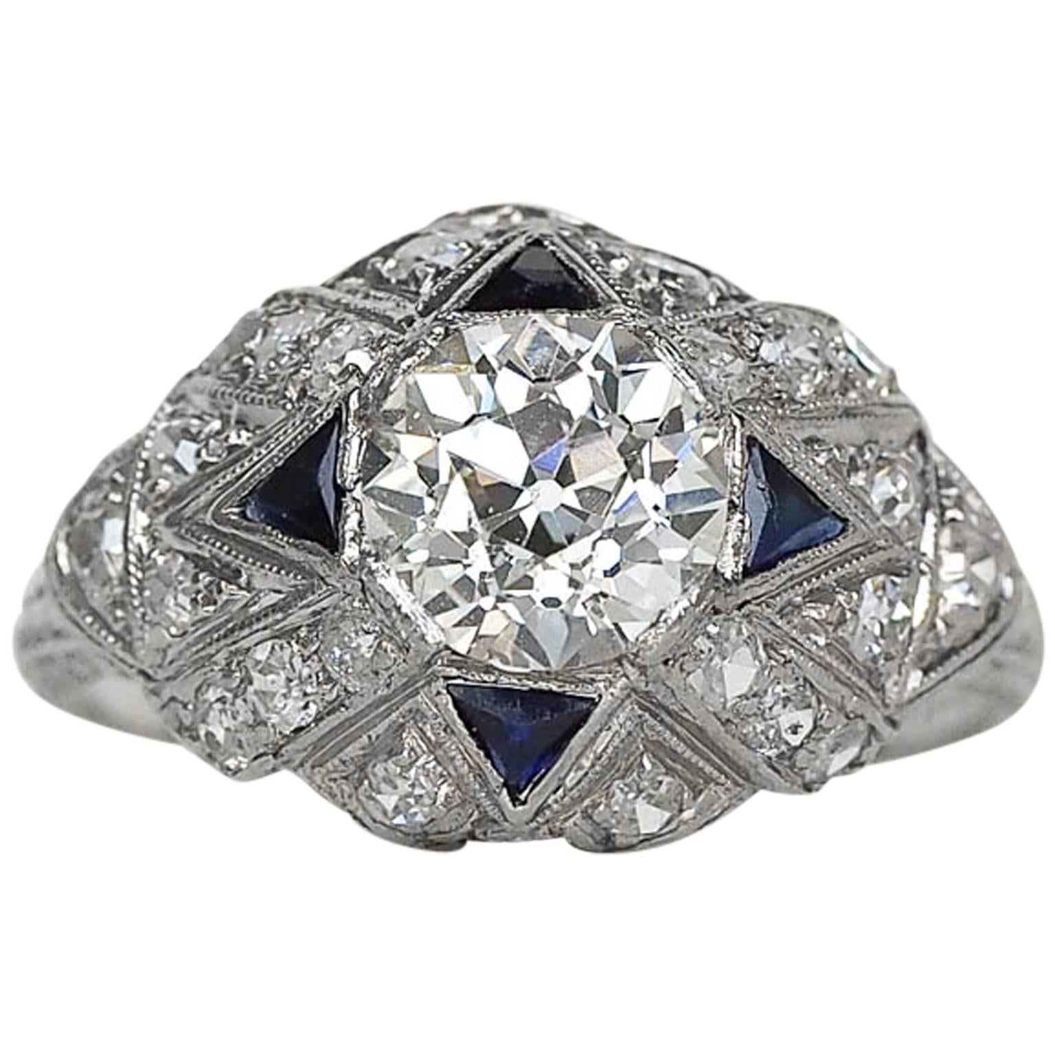 Here we have an Antique Art Deco diamond engagement ring. This fantastic ring has a GIA certified 1.28ct center stone that is true eye catcher. The diamonds and sapphires surrounding the center stone are all individual designed to give each stone a