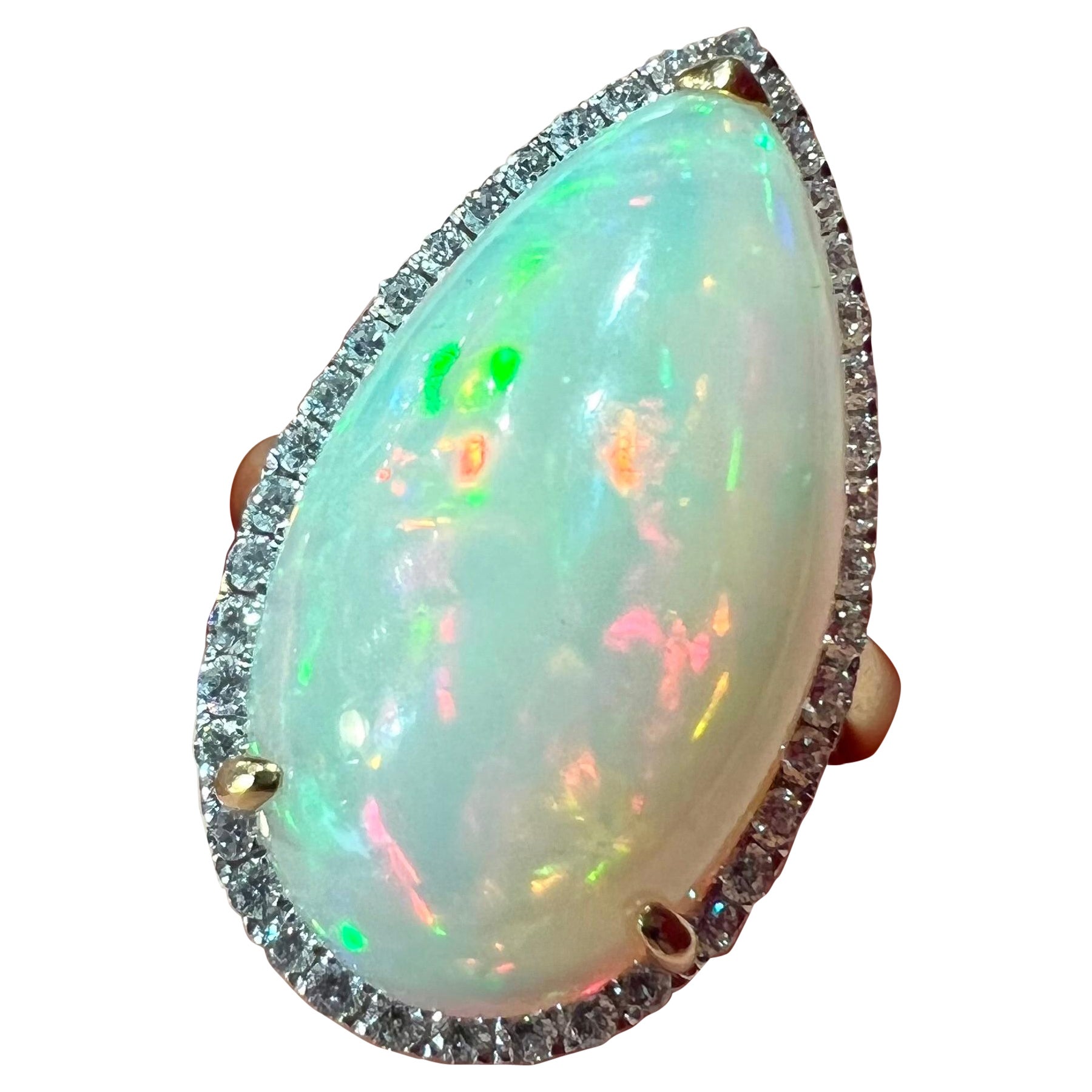 18ct Gold Ring Set with an Opal Surrounded by Diamonds