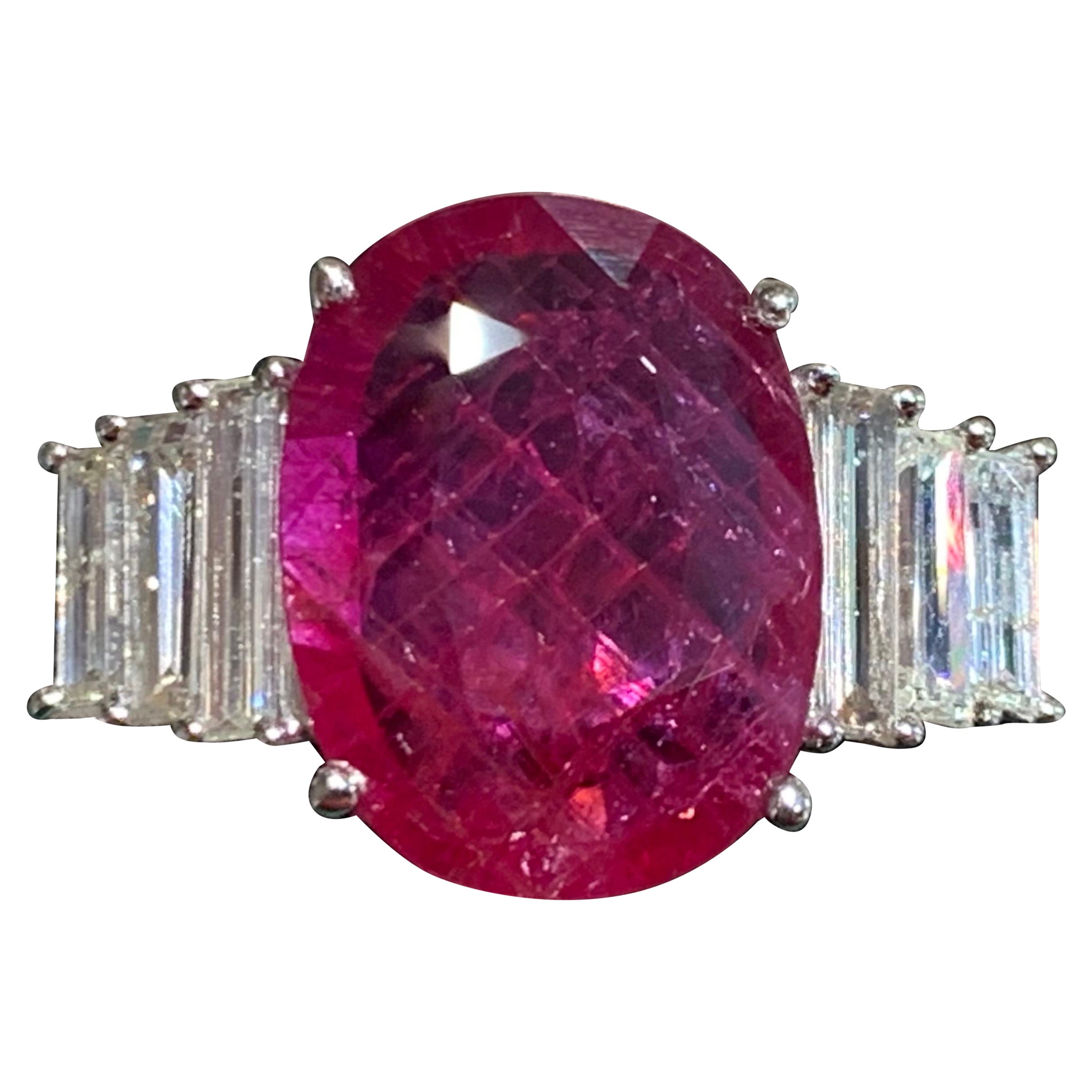 18ct white gold ring set in its center with a large ruby, 
6 baguette diamonds : 0.86 carat 
provided with a laboratory certificate, 
ruby : 5.15ct size of the faceted oval ruby: 
approximately 1.4cm by 1cm 
total weight: 7.40 gr
 size 54 