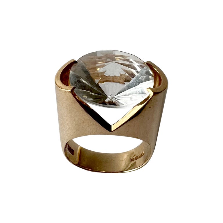Crystal and 14K gold ring created by Hans Hansen of Denmark, circa 1960's. Faceted tension set crystal suspends mid air in its 14K gold setting.  Ring stands about .75