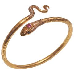 18K Gold Snake Bracelet with Pave` Diamonds, Ruby and Sapphire Eyes