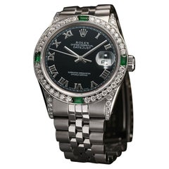 Vintage Rolex Datejust Black Roman Dial Diamond/Emerald Bezel Stainless Steel Watch