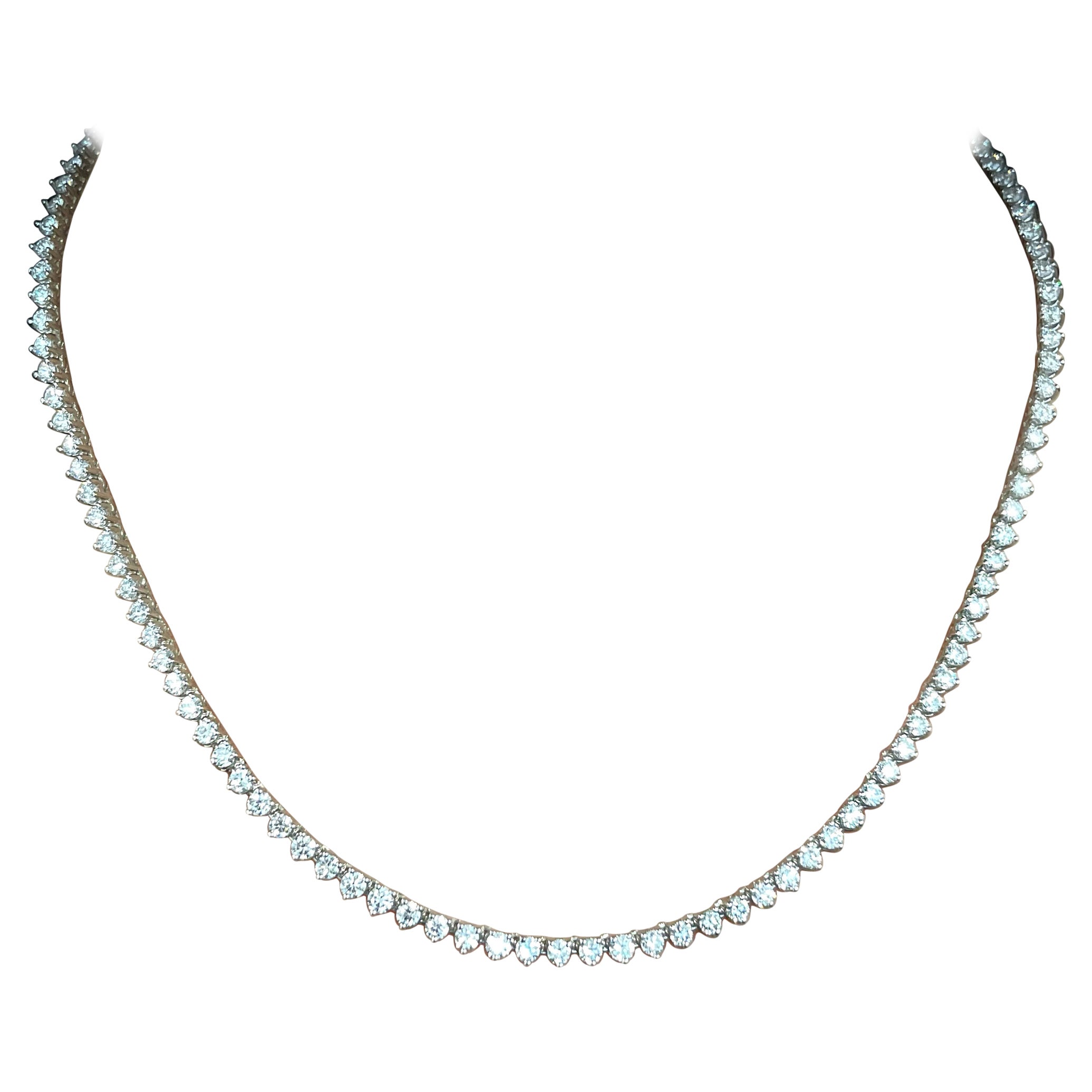 This classic diamond tennis necklace features 136 diamonds weighing 5.27 ct set in 14k white gold. The diamonds are graded F-G in color and VS2-SI1 in clarity. The diamonds are of exceptional quality and are set in a classic tennis style. The