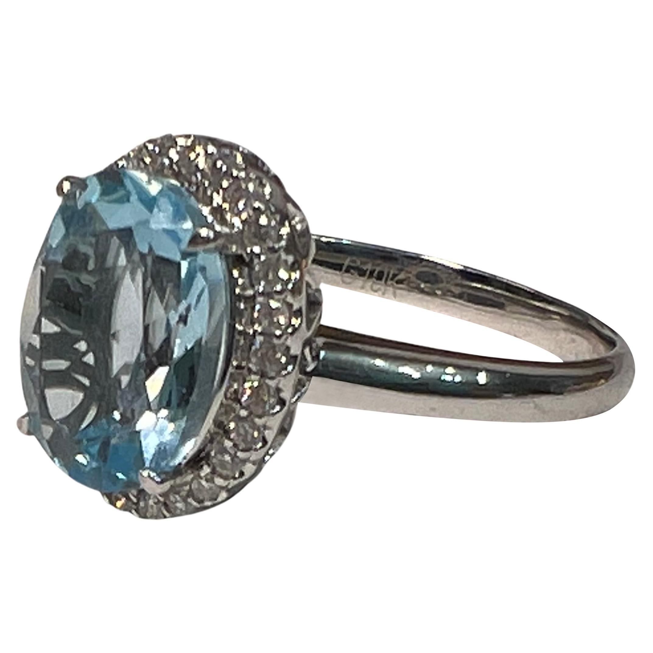3.45ct Baby Blue Oval Topaz with .2ct halo of diamonds. Set in white 10k gold. 

This impressive piece is the perfect engagement ring or anniversary ring. The 3.45ct oval-shaped baby blue topaz is rose cut to enhance the shine and lure of this