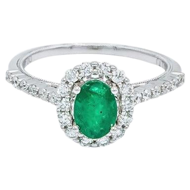 Oval Shaped Emerald with Diamond Halo and Simple Diamond Band Engagement Ring For Sale