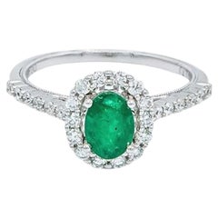 Oval Shaped Emerald with Diamond Halo and Simple Diamond Band Engagement Ring