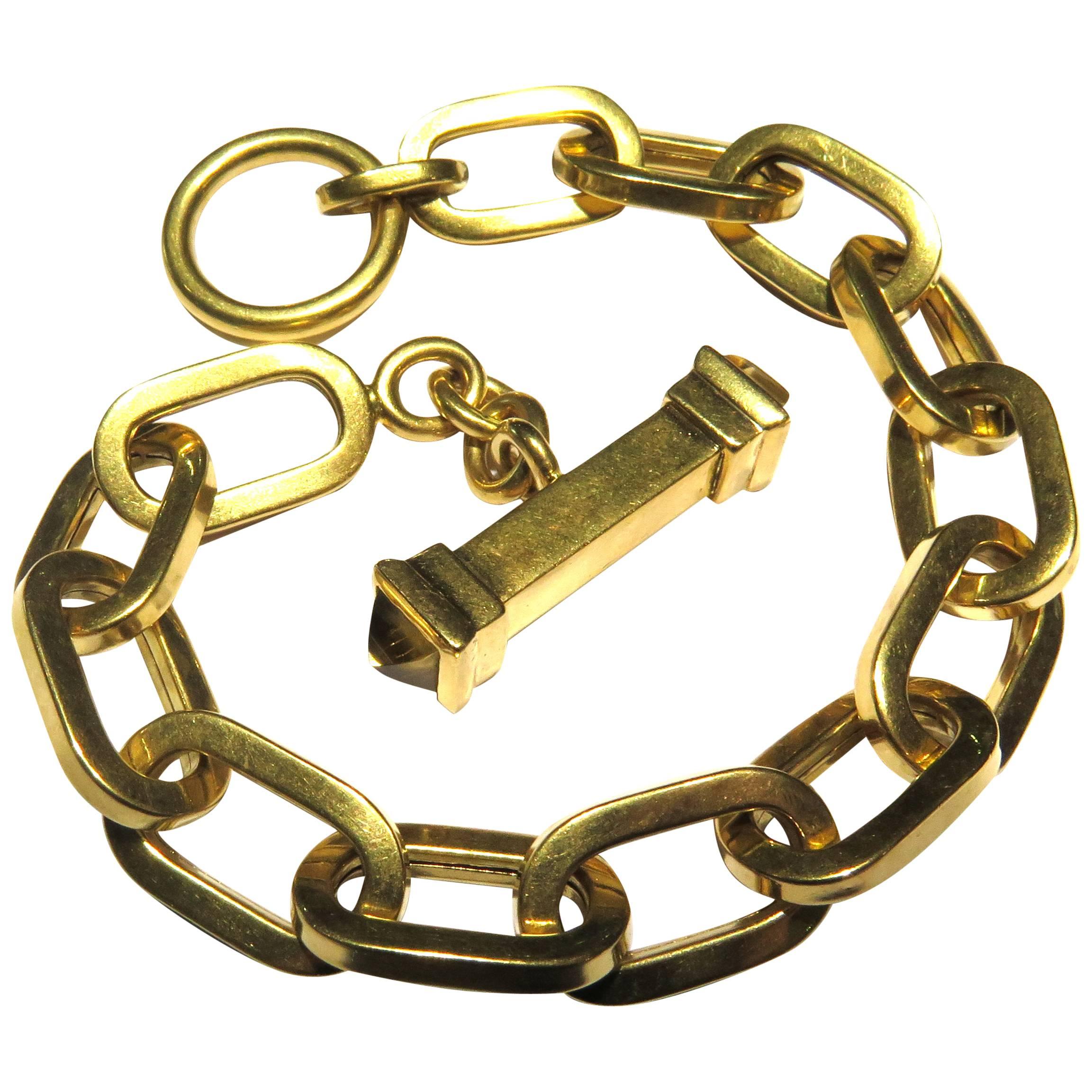This 18k bracelet is so easy to wear, you will want to wear it everyday! It's hollow, but not light. It weighs 27.2 grams. The oversized links are very flattering on the wrist. This bracelet is marked 18k Italy and there is some type of hallmark