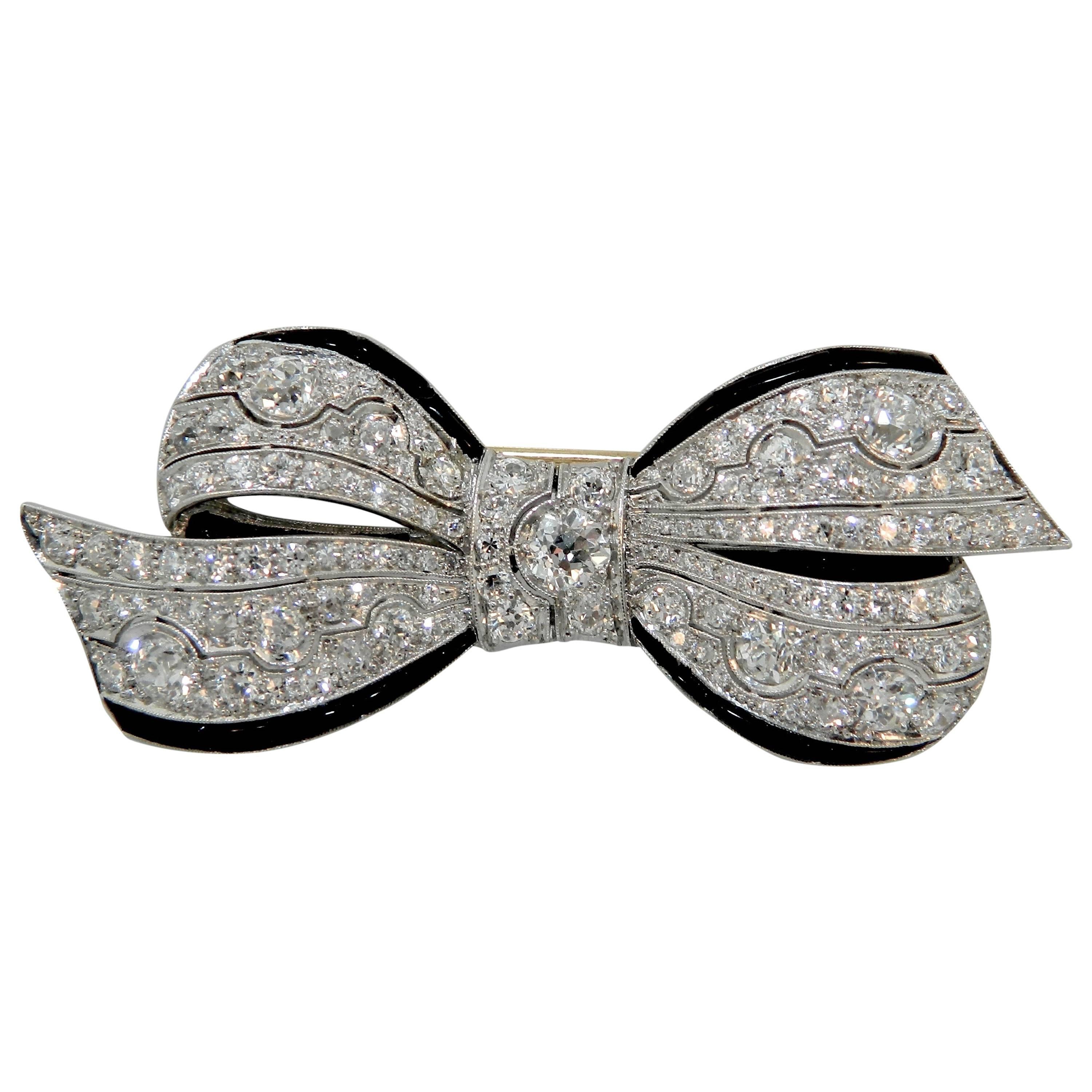 1920s Art Deco Onyx Diamond Platinum Ribbon Brooch For Sale