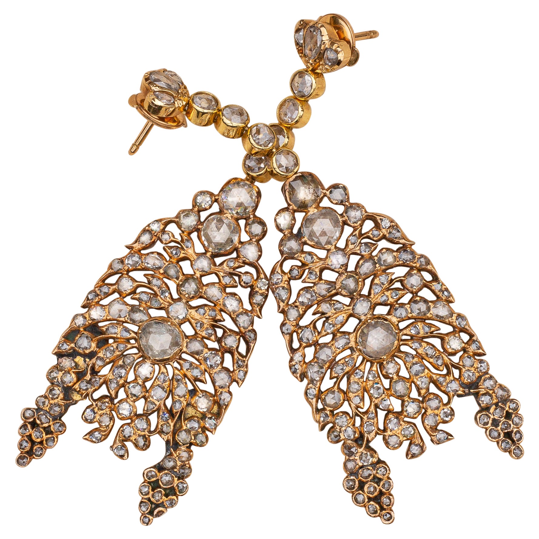 A spectacular pair of diamond chandelier earrings dating to the early 19th century. Each earring features 122 rose cut diamonds of varying sizes (244 in total) in rub over and closed back gold settings, weighing approximately 4ctw. 

These elegant
