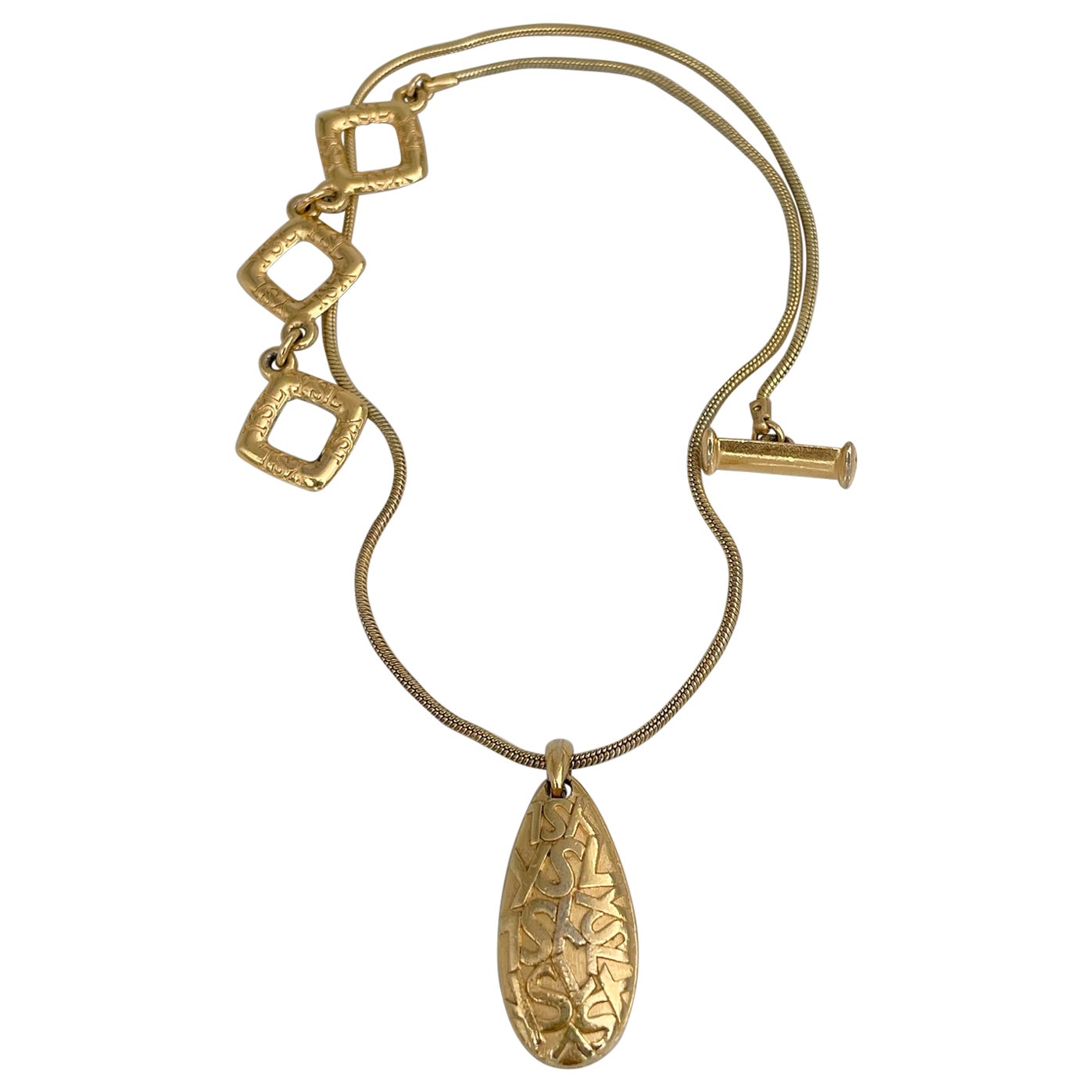 1980s Vintage Yves Saint Laurent YSL Gold Tone Monogram Drop Pendant Necklace For Sale