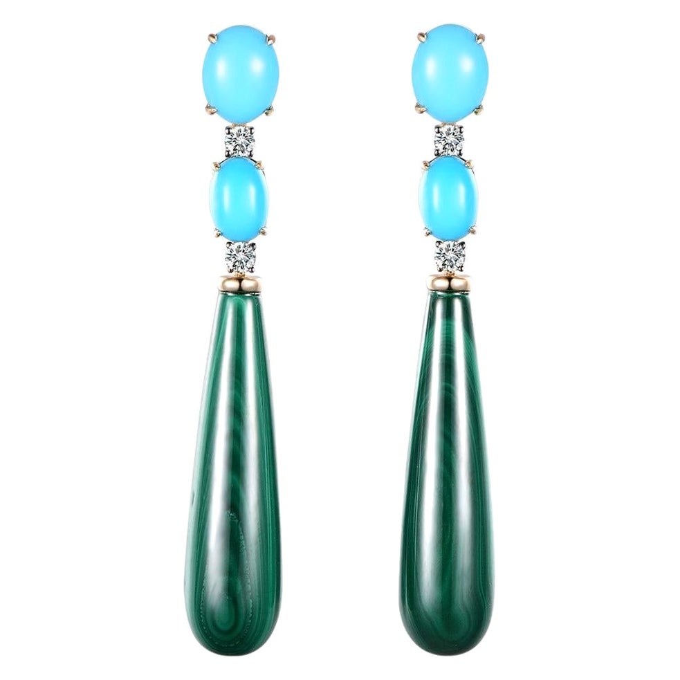 Unveiling our exquisite earrings featuring Sleeping Beauty Turquoise and Malachite, set in 14 Karat Yellow Gold. These enchanting earrings are a celebration of natural beauty, combining unique gemstones with luxurious gold to create a truly