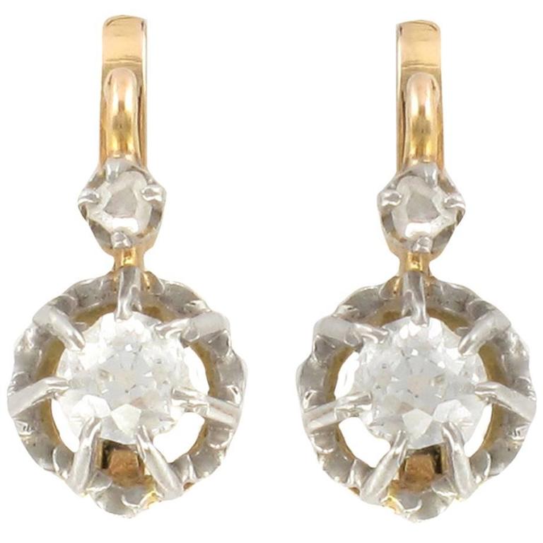 Pair of gold and platinum sleeper earrings adorned with … | Drouot.com