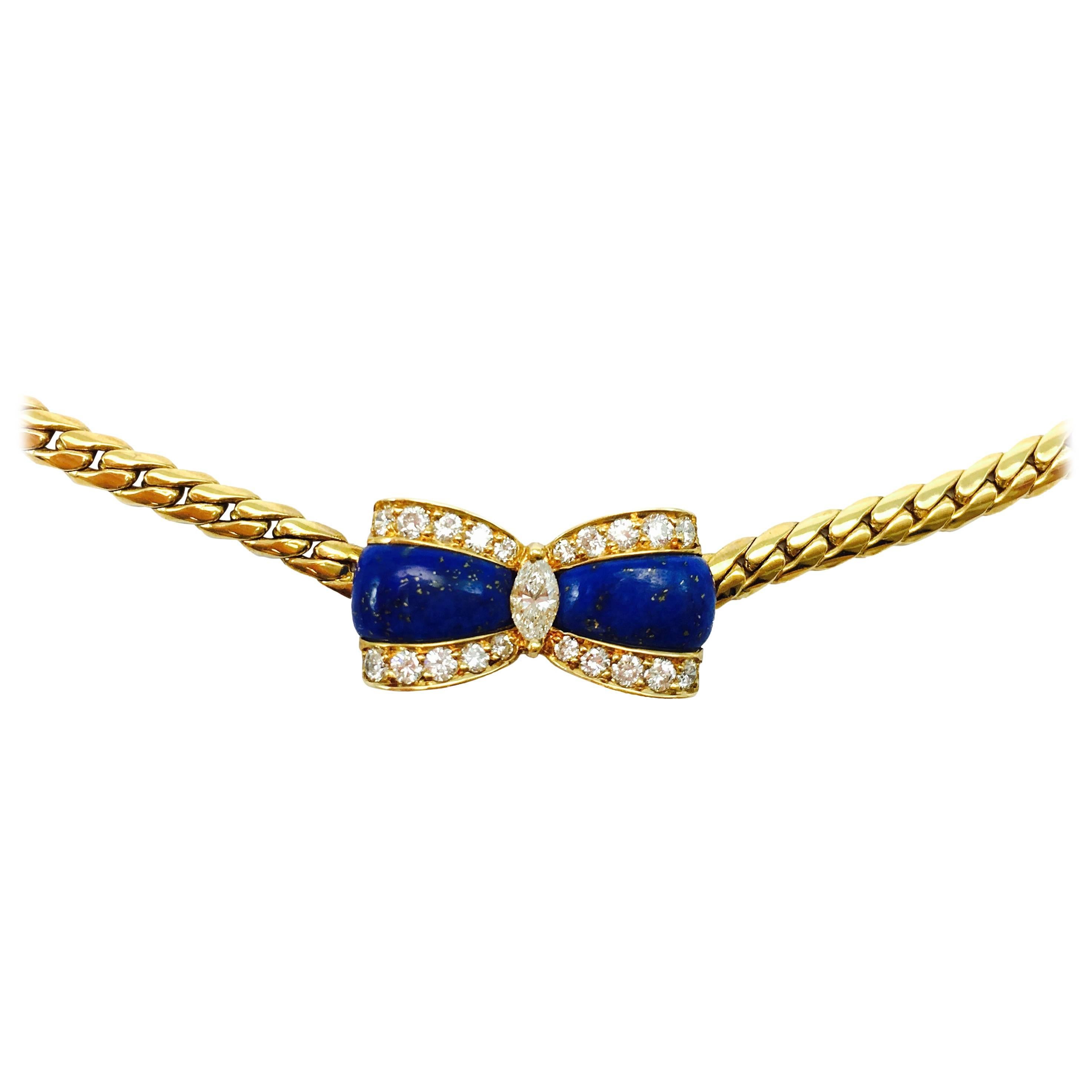 Rare 18K yellow gold necklace, featuring a curved lapis lazuli bow set with one marquise cut diamond in the center and twenty round brilliant cut diamonds. Approximate total diamond weight: 0.75 ct. Color: F-G, Clarity: VS
The bow measures: 22.5 mm
