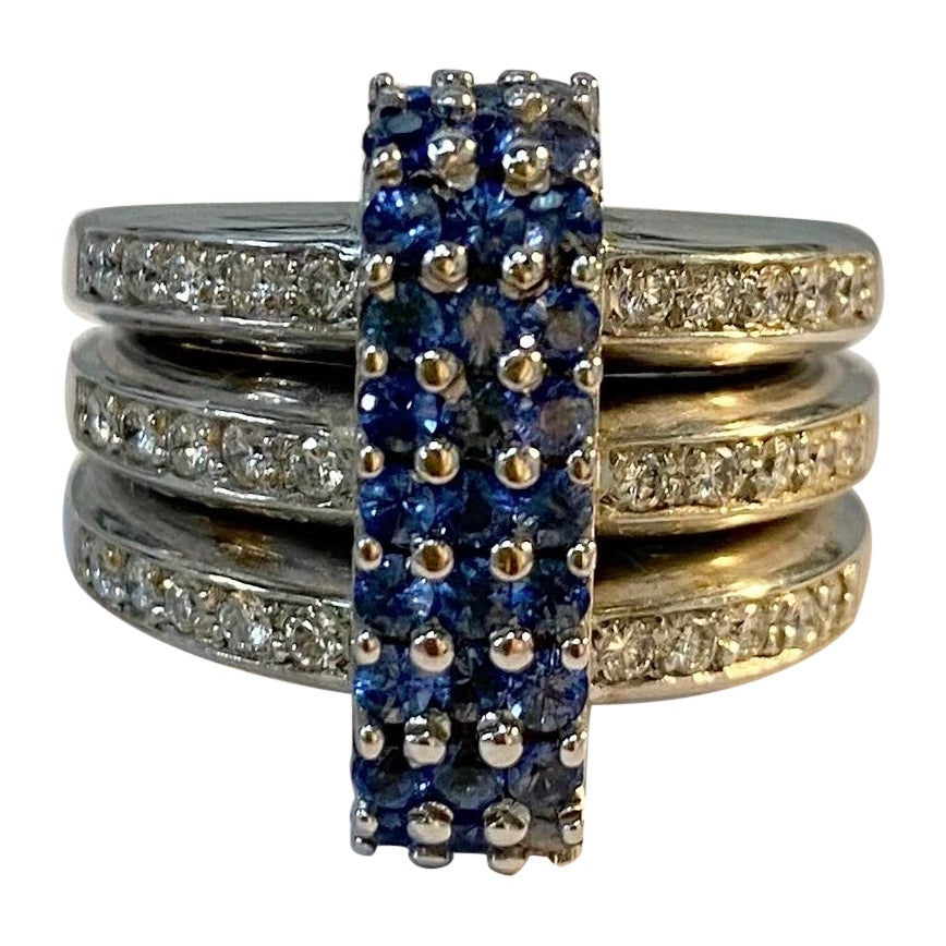Stunning bluish-purple blue Sapphires and Diamonds are set in a three-fused white gold band. The ring is solid 18k white gold and really feels weighty on the finger. It is a one-of-a-kind ring and truly unusual. It was handmade in Toronto in 1990.