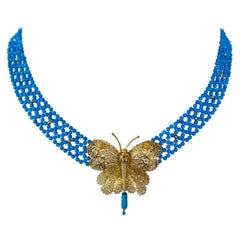 Marina J. Türkisfarbene gewebte Halskette mit Gelbgold-Schmetterlings-Tafelaufsatz