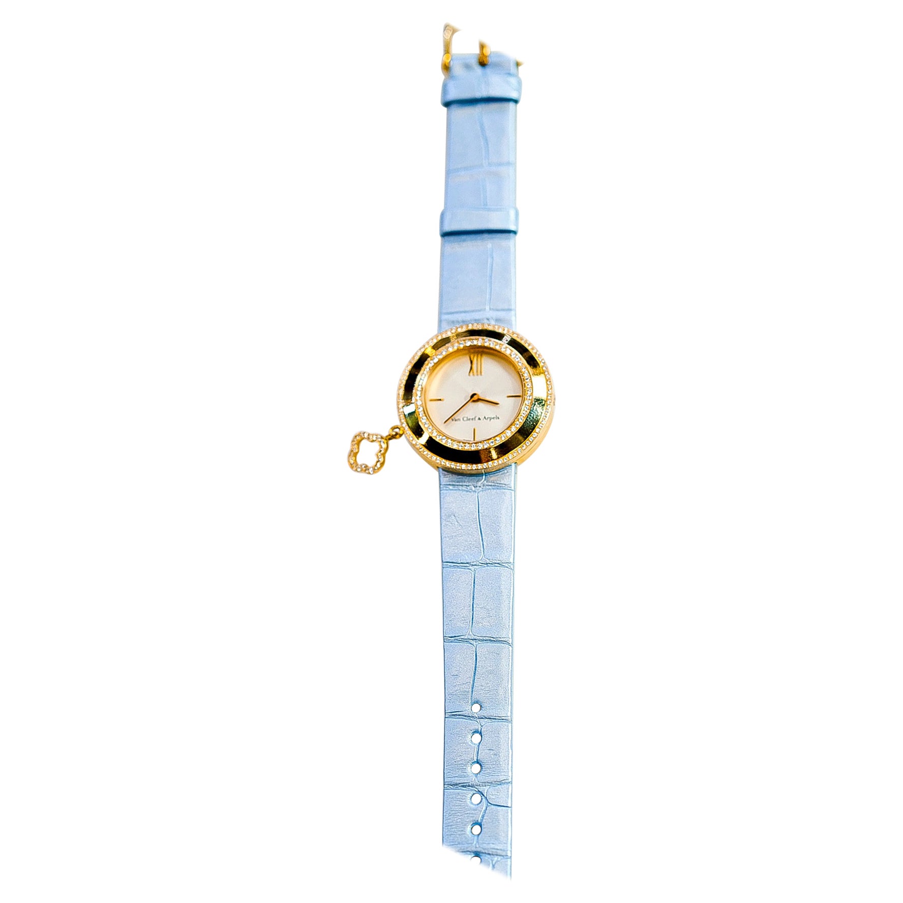Van Cleef & Arpels 18K Yellow Gold Diamond Charm and Blue Alligator Watch.

The epitome of luxury with this stunning VCA charm watch, a true marvel of craftsmanship and elegance. 

Meticulously crafted from 18 karat gold, this timepiece exudes a