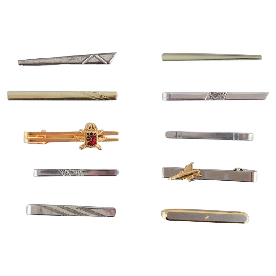 A collection of ten Danish tie pins in sterling silver and gold-plated metal. 
