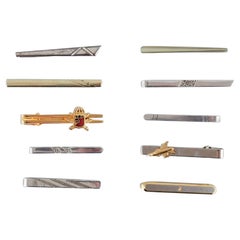 A collection of ten Danish tie pins in sterling silver and gold-plated metal.