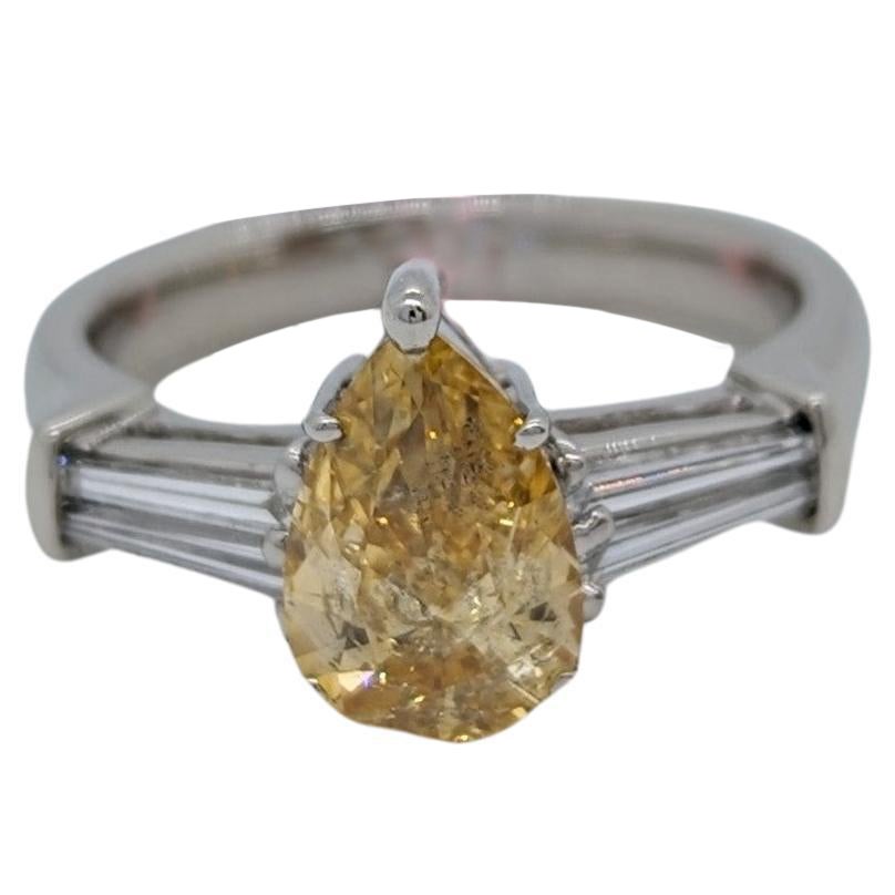 GIA Fancy Orangy Yellow Pear and White Diamond Three Stone Ring in Platinum For Sale