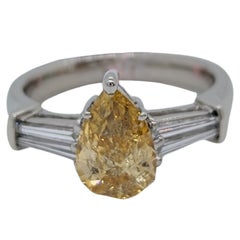 GIA Fancy Orangy Yellow Pear and White Diamond Three Stone Ring in Platinum