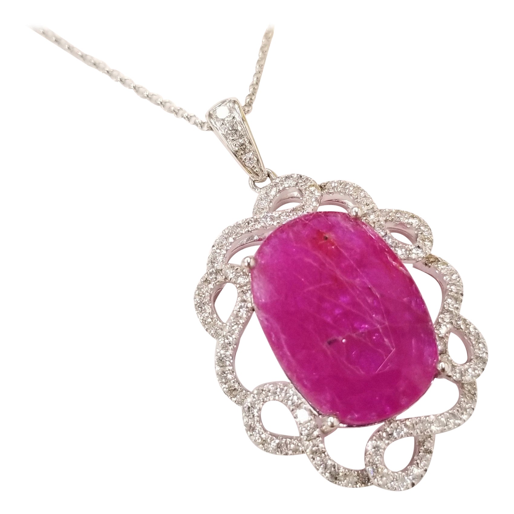 Collectible unheated ruby pendent.
The ruby weighs an impressive 8.88 carat and has a beautiful oval shape along with an deep purlish-red color that makes it so special. It is complemented by 0.99 carats of round brilliant-cut diamonds adding