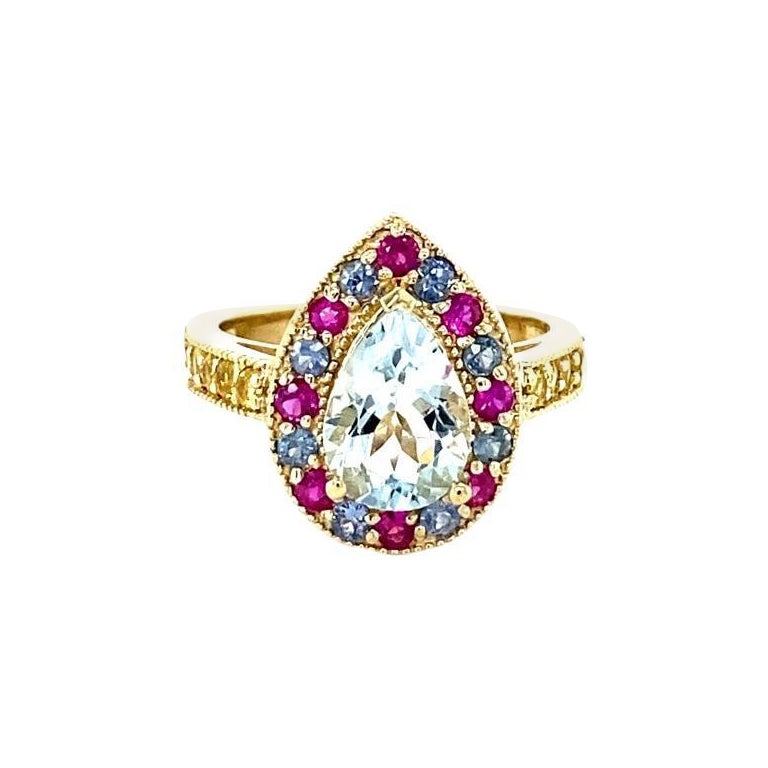 2.75 Carat Aquamarine Multi Color Sapphire Yellow Gold Cocktail Ring

This ring has a gorgeous 1.54 Carat Pear Cut Aquamarine and is surrounded by 28 Natural Blue, Pink and Yellow Sapphires that weigh 1.21 carats.
The Total Carat Weight of the ring
