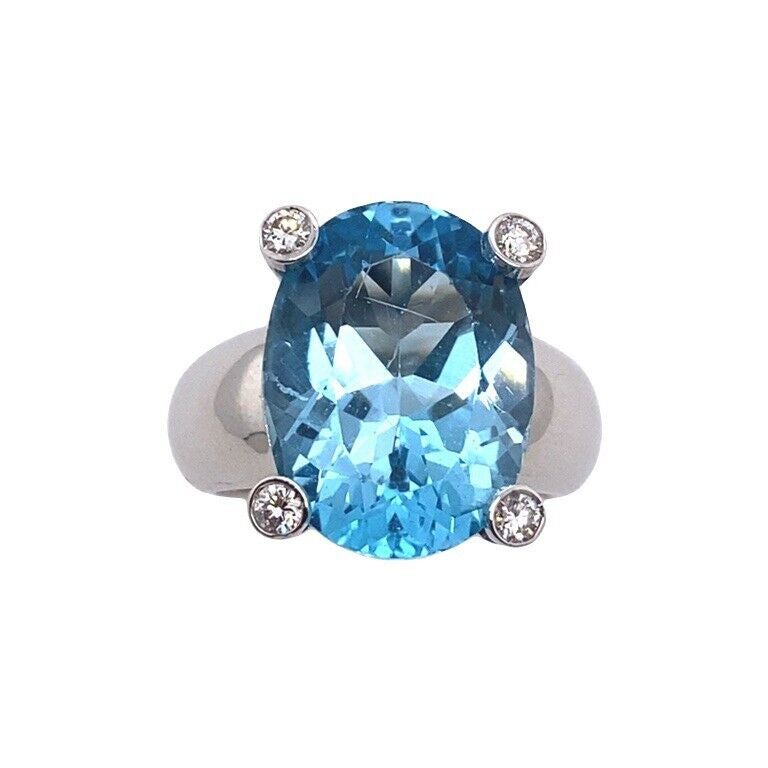 Italian Made 7.0ct Oval Facetted Blue Topaz Ring with a Diamond on Each Corner For Sale