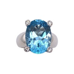 Bague en topaze bleue ovale facettée de 7,0 carats de fabrication italienne avec un diamant de chaque côté