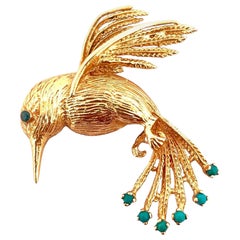 Broche oiseau en or jaune 14 carats avec 6 pierres précieuses turquoises et yeux en diamant bleu