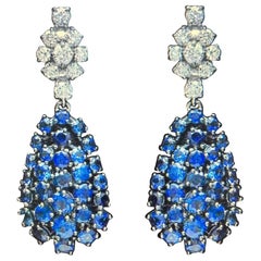 14kt. gold diamond and round cut brilliant deep blue sapphire earrings