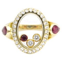 Anello Chopard con diamante ovale e rubino in oro giallo 18 carati