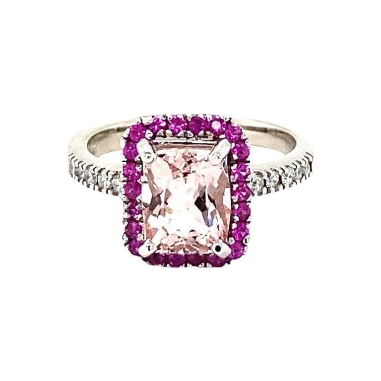 A lovely Engagement Ring Option or as an alternate to a Pink Diamond Ring! 

This gorgeous and classy Morganite and Diamond Ring has a 1.88 Carat Emerald Cut Pink Morganite and is surrounded by a simple halo of 22 Pink Sapphires that weigh 0.36