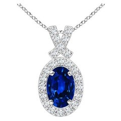ANGARA Colgante de zafiro azul natural de 0,60 ct con halo de diamantes en platino