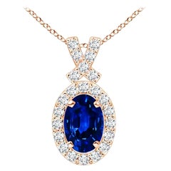 ANGARA Colgante de zafiro azul natural de 0,60 ct con halo de diamantes en oro rosa de 14 quilates
