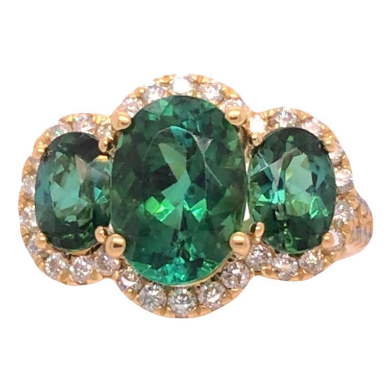 4.62 Carat Oval Cut Green Tourmaline 3-Stone Ring with Dia Halo in 18Y ref1612 For Sale