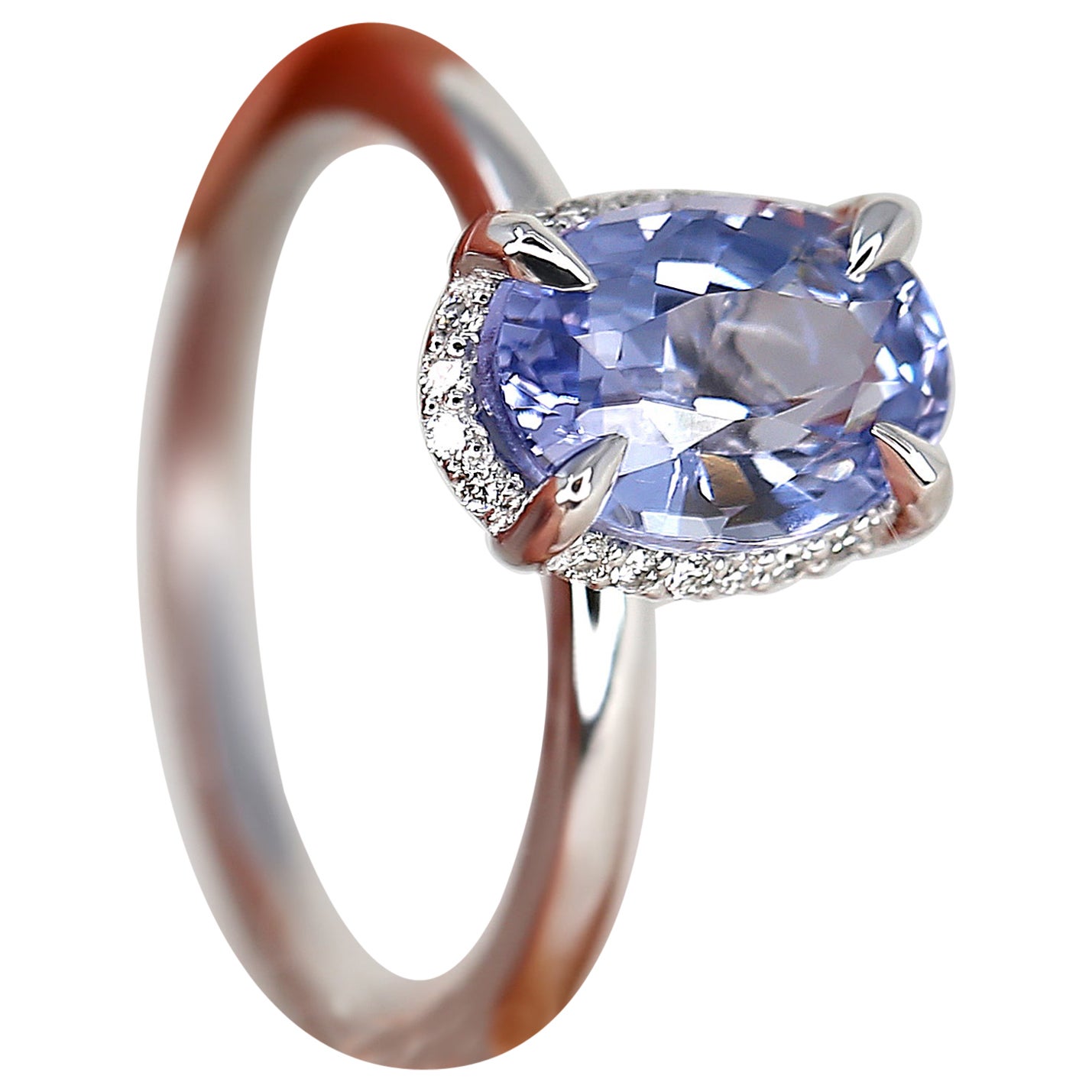 Experience the epitome of luxury with our 2.49ct Waverly sapphire ring, where secret diamonds gracefully peek from above. This exquisite piece features a stunning cornflower blue sapphire with lavender undertones, beautifully set in a 14kt white