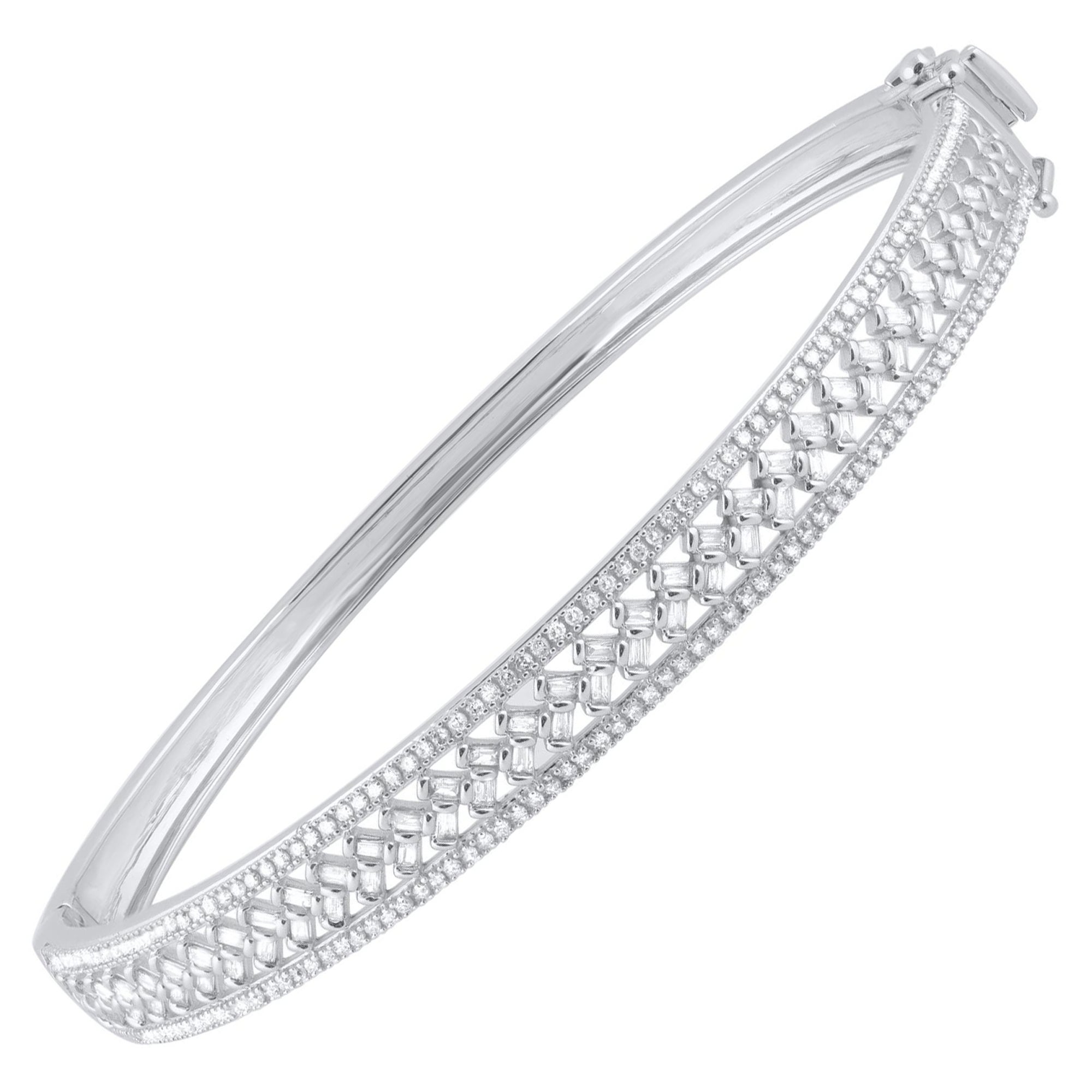 Classic and sophisticated, this diamond bangle bracelet pairs well with any attire.
This Shimmering bangle bracelet features 228 single cut & baguette natural diamonds in prong & channel setting and crafted in 14 kt white gold. Diamonds are graded