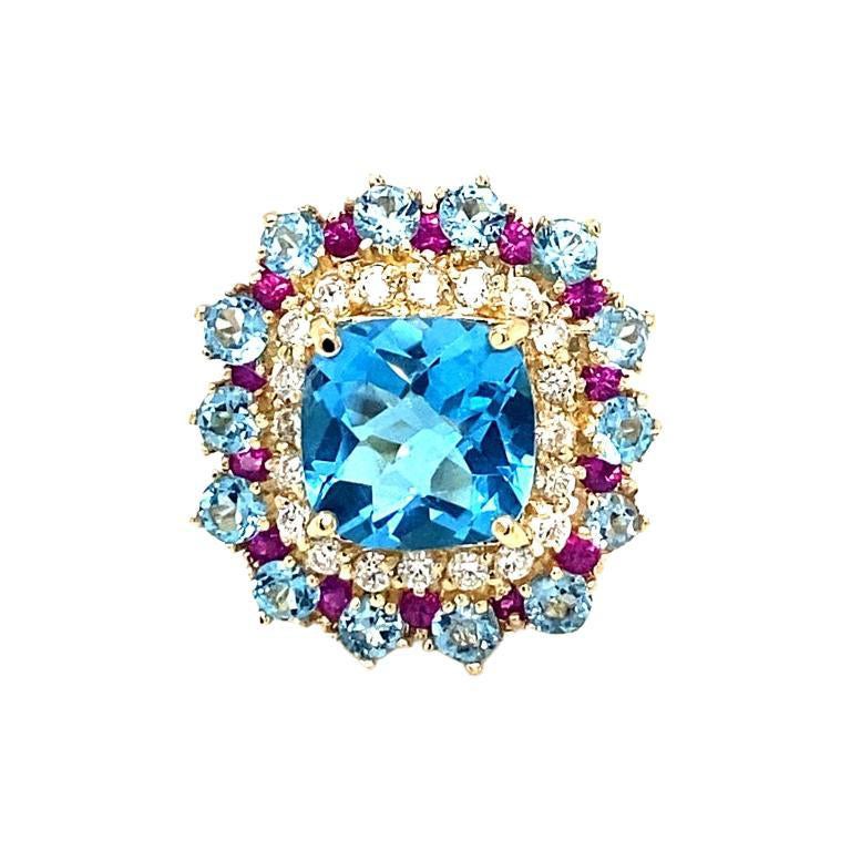 6.41 Carat Blue Topaz Sapphire Diamond Yellow Gold Cocktail Ring

Beautiful to say the Least! 

This Ring has a magnificent Cushion Cut Blue Topaz that weighs 3.93 Carats and is surrounded by 14 Blue Topaz that weigh 1.73 Carats, 14 Pink Sapphires